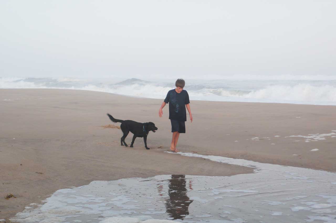Image of a boy with his dog on Main Beach