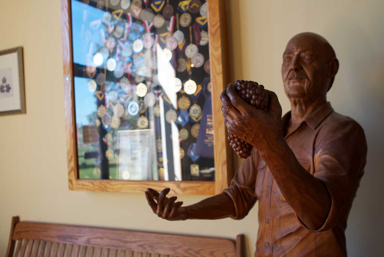 Image of Wooden Sculpture of Dr. Damianos at Duck Walk Tasting Room