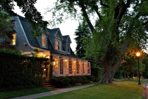 Mill House Inn Front Porch Glowing in a Summer Evening